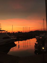 Sailboats in marina at sunset