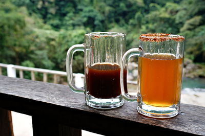 Two beer mugs in a restaurant bar near an ecological reserve on a hot rest day