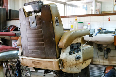 Close-up of old arm chair at salon