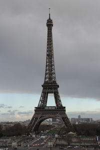 Low angle view of eiffel tower against cloudy sky