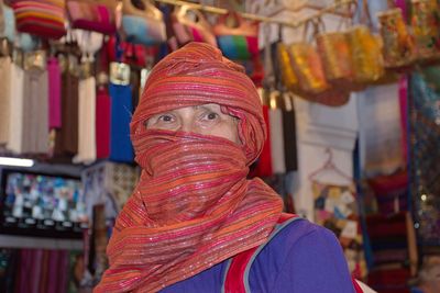 Close-up portrait of woman wearing headscarf at store