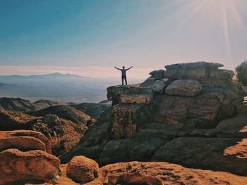 Man standing on mountain against sky