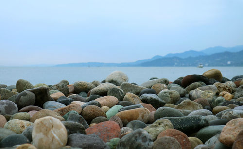 Rocks on beach against sky