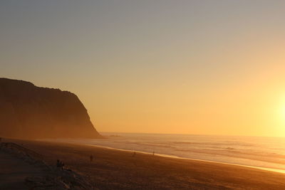 Scenic view of sea against clear sky during sunset