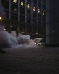 Smoke emitting from illuminated building at night