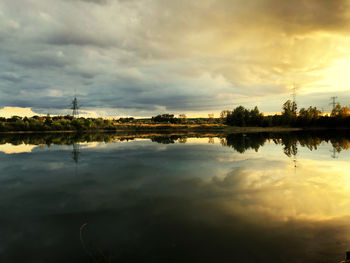 Scenic view of lake against sky at sunset