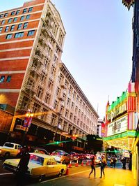 View of city street and buildings against sky