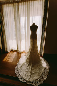 Wedding dress against curtain