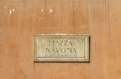 Close-up of text on wooden wall