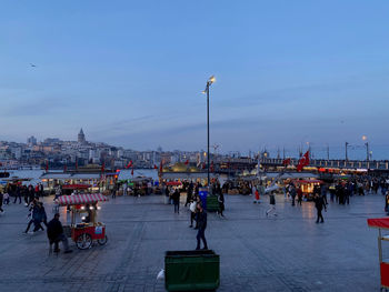 People walking on street in city at dusk