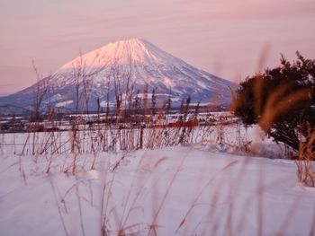 Scenic view of snow covered mountains against sky during sunset
