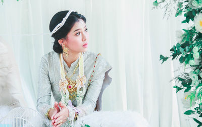 Bride wearing traditional clothing looking away