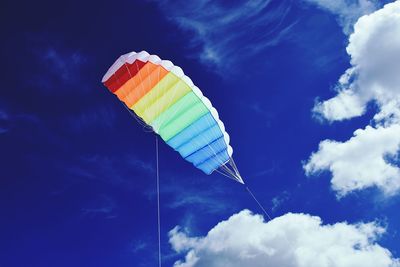 Low angle view of colorful kite flying in sky