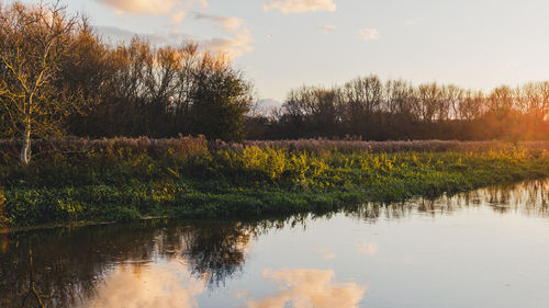 Scenic view of lake against sky at sunset