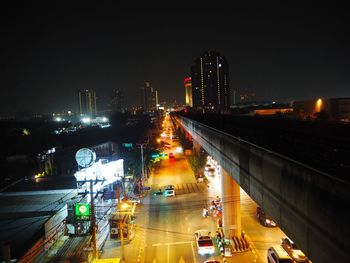 High angle view of illuminated cityscape against sky at night