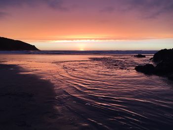 Scenic view of sea against orange sky