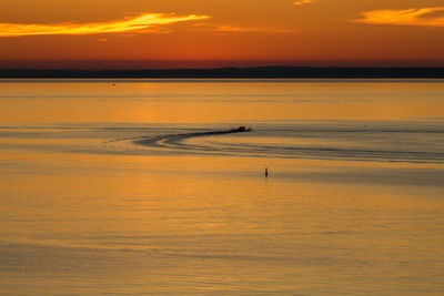 Scenic view of sea against orange sky