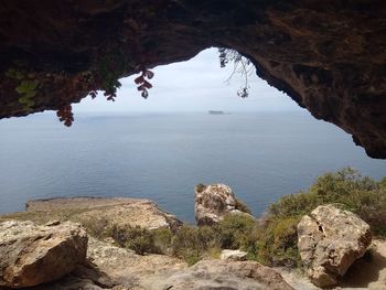 Scenic view of sea and rock formation against sky