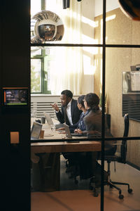 Rear view of woman sitting in cafe