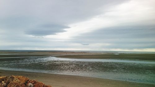 Scenic view of sea against cloudy sky