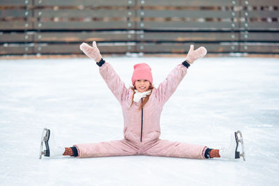 Rear view of woman standing on snow