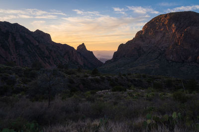 Scenic view of rocky mountains against sky during sunset