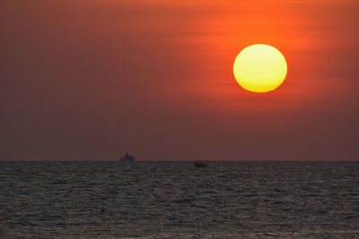 Scenic view of sea against orange sky