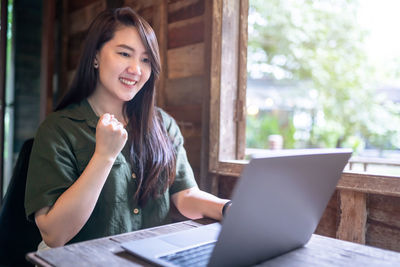 Young woman using laptop at office