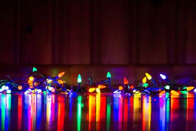Colorful illuminated lighting equipment on floor with reflection