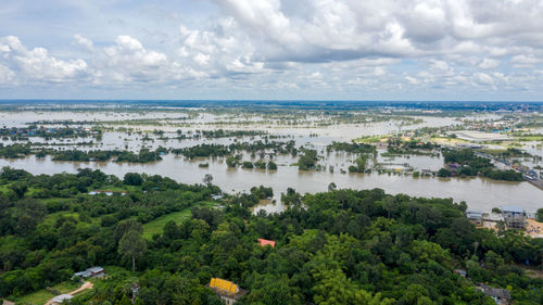 High angle view of trees and sea against sky