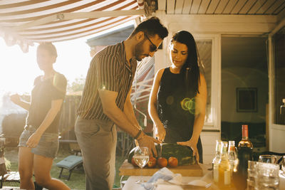 Young man and woman standing on table