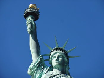 Low angle view of statue against blue sky