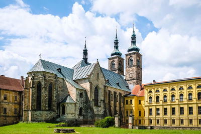 Buildings against cloudy sky