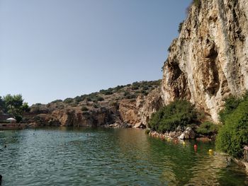 Scenic view of sea and mountains against clear sky