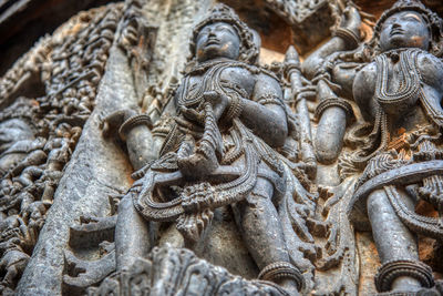 Close-up of buddha statue against historic building