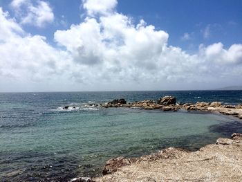 Scenic view of sea against cloudy sky