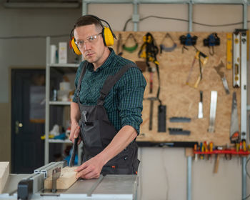 Portrait of young man working in workshop