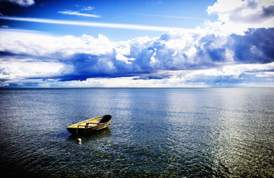 Boat moored on sea against sky