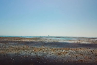 Scenic view of sea against clear blue sky