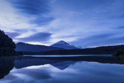 View of mount fuji at sunrise on a peaceful morning from lake saiko, yamanashi prefecture, japan