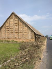 Old house on field against sky