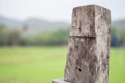 Close-up of wooden post on field