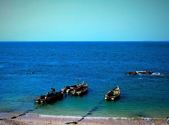 High angle view of boats in calm blue sea