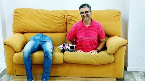 Man sitting on sofa at home