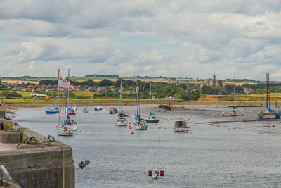 Scenic view of river against cloudy sky