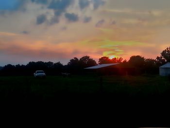 Scenic view of landscape against sky at sunset