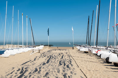 Sailboats on beach against sky