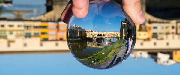 Close-up of man holding glass of building