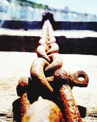 Close-up of rusty chain against sky