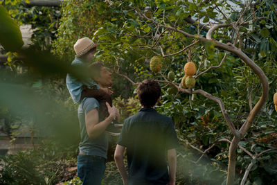 Adventurous family inspecting tropical gallery in botanical garden. local travel